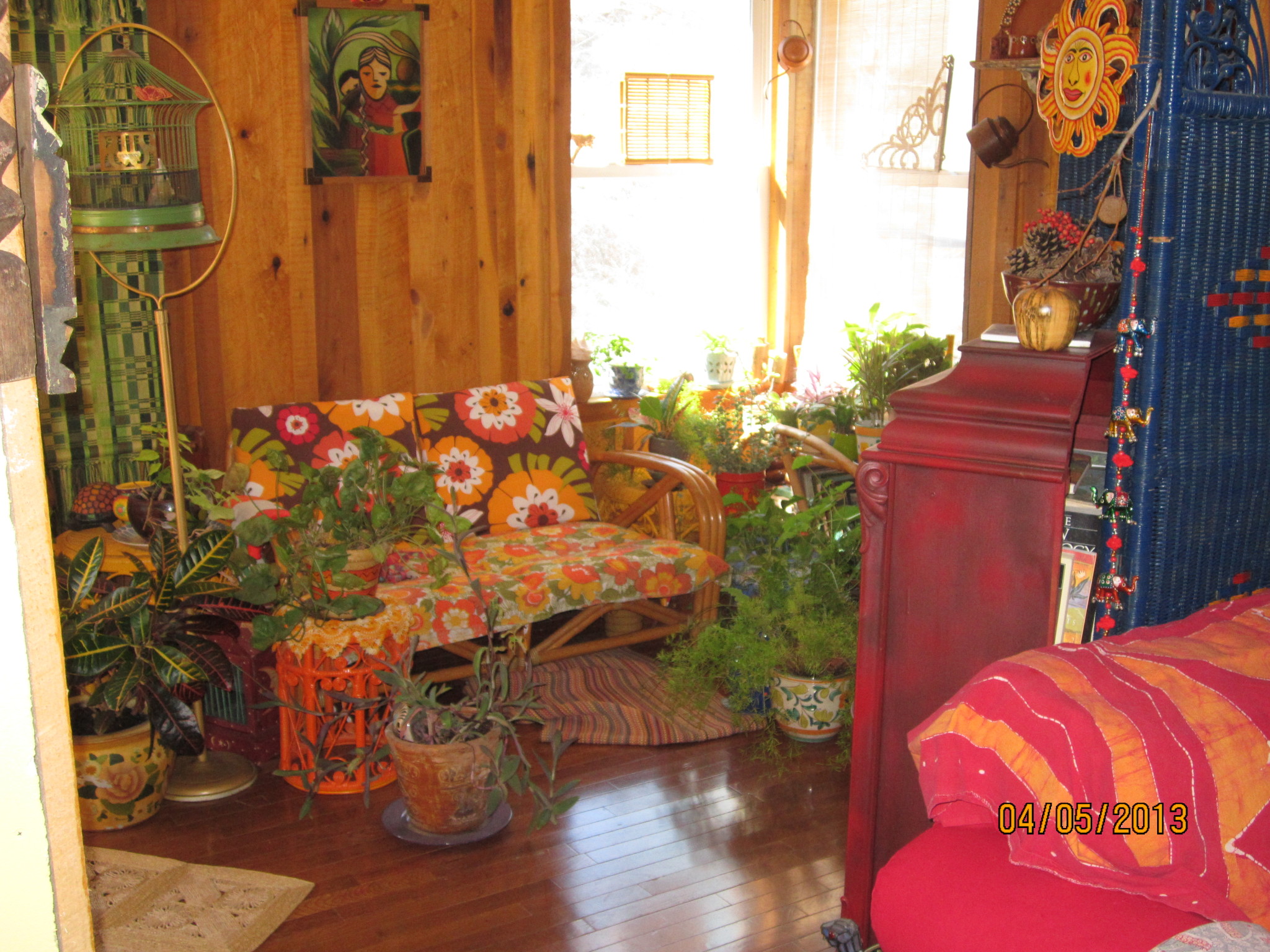 Interior of a cozy, colorful room with plants and vibrant decor.