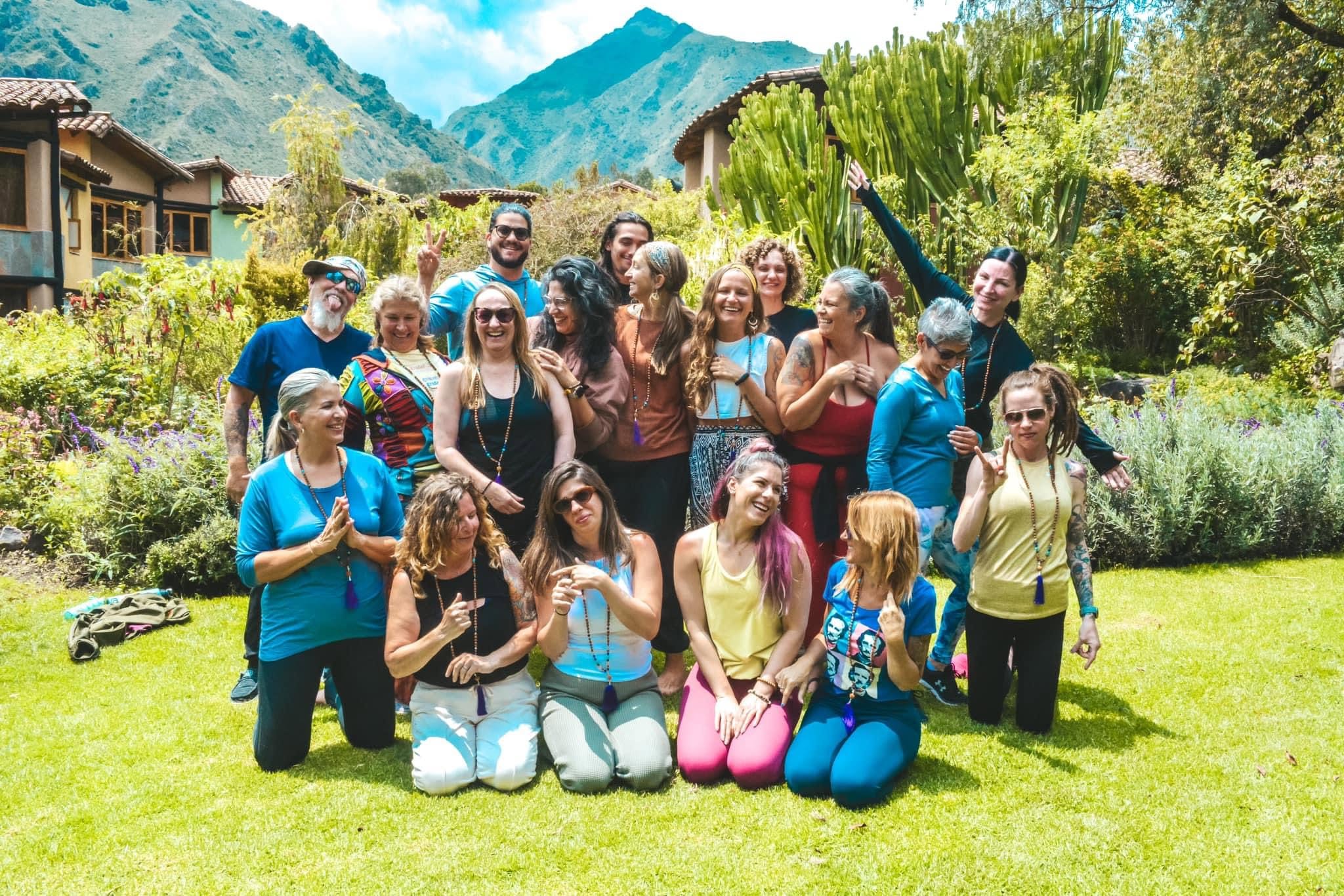 Group of diverse people enjoying outdoor community event in scenic setting.