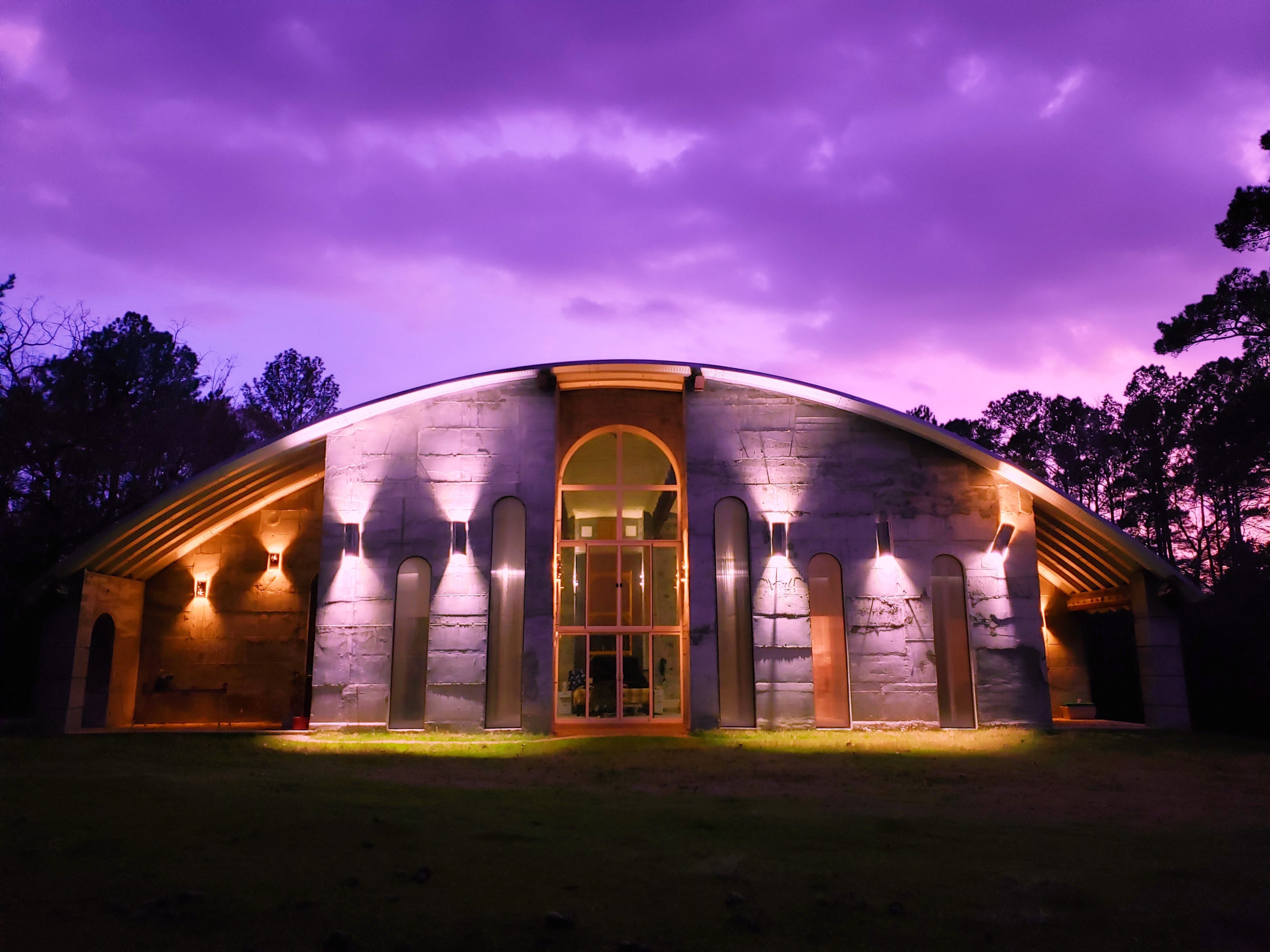 Modern community center with illuminated exterior at dusk.