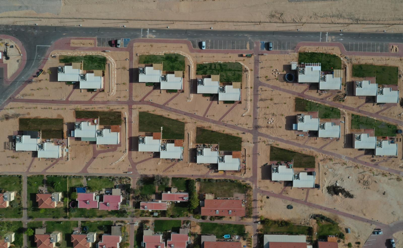 Aerial view of Kibbutz Ketura with modern homes and green spaces.