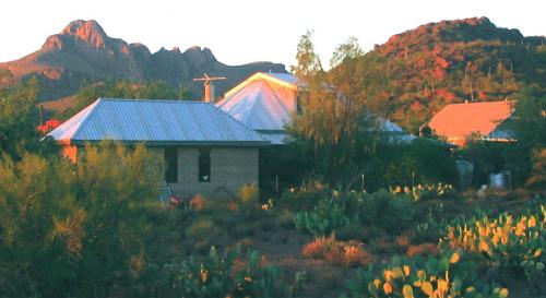 Scenic view of community buildings with mountains in the background.
