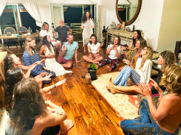 Group of people sitting in a circle during community event at Sundari Gardens.