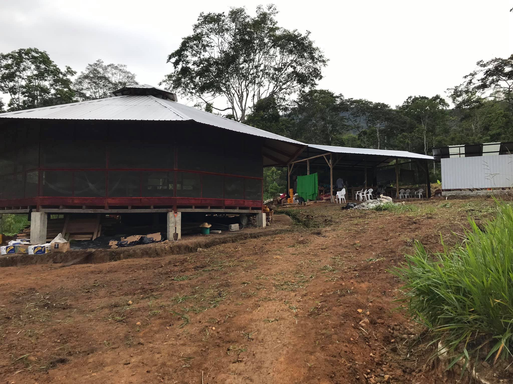 Community center with a curved roof in a rural setting.