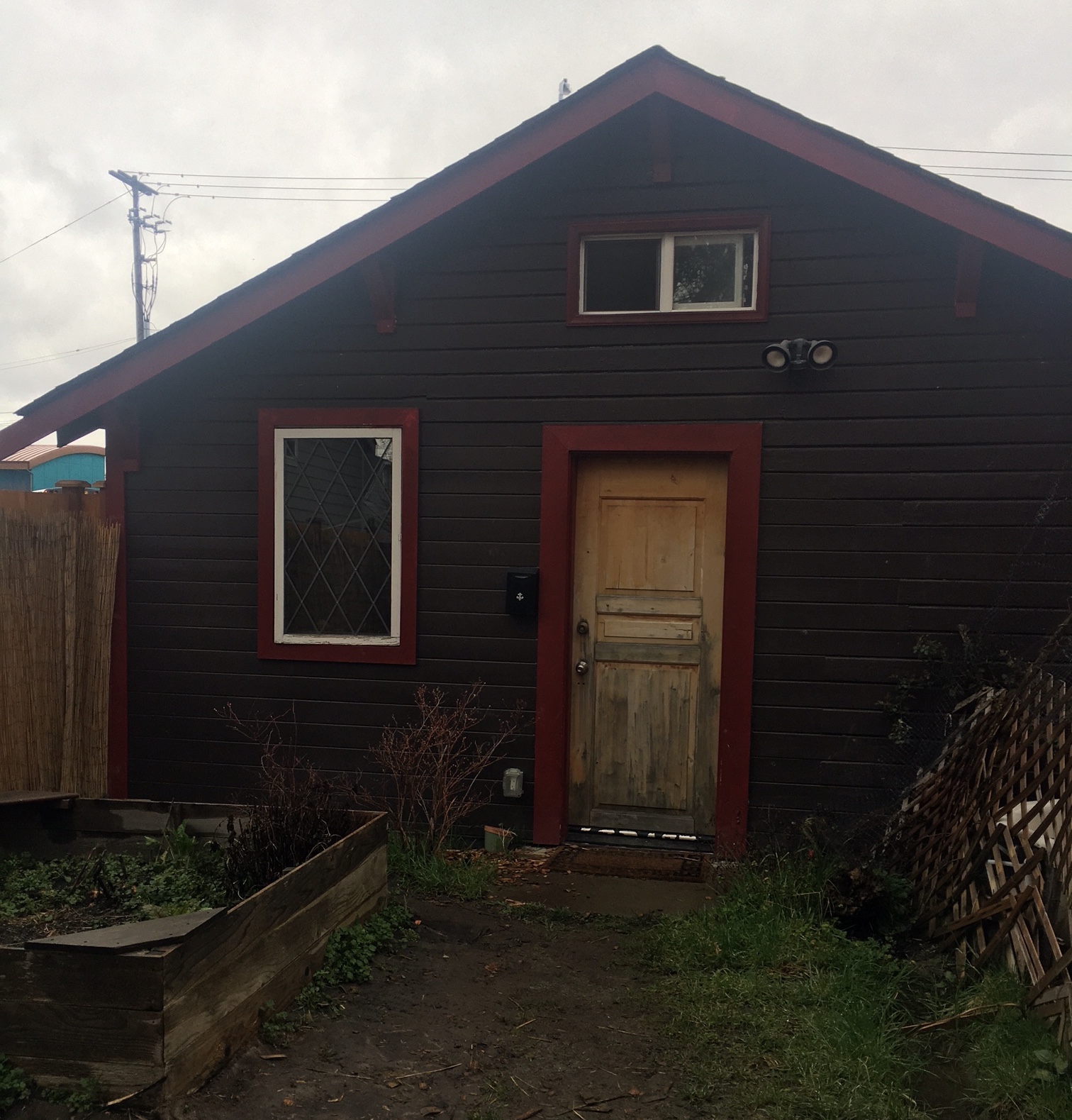Co-housing tiny house in Seattle with garden and wooden fence.