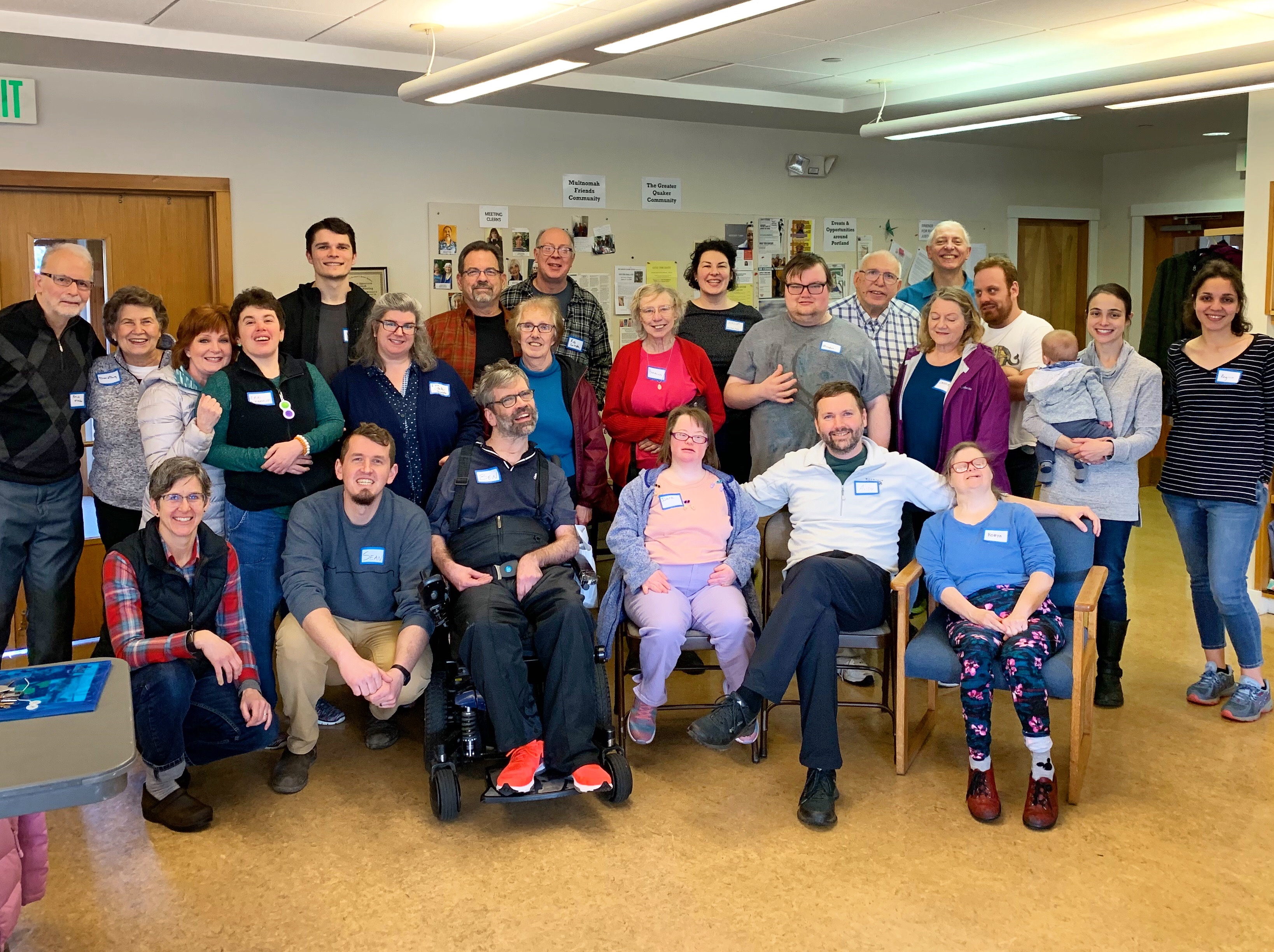 Group photo of diverse community members at L'Arche Portland event.