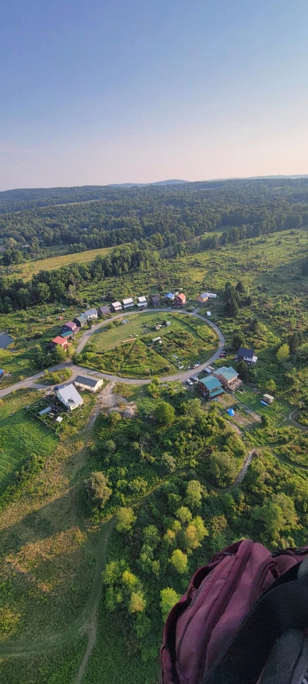 Aerial view of White Hawk Ecovillage with sustainable homes and green landscapes.
