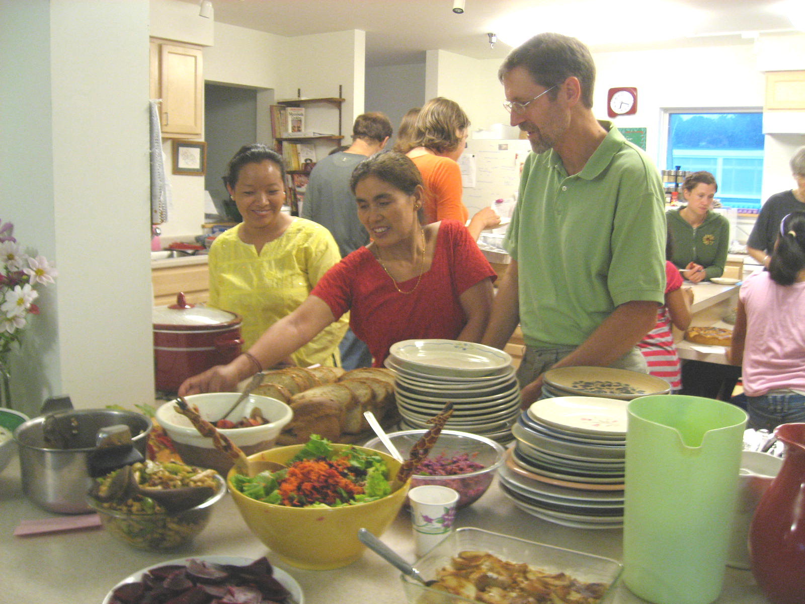 People enjoying a communal meal at Burlington Cohousing East Village.