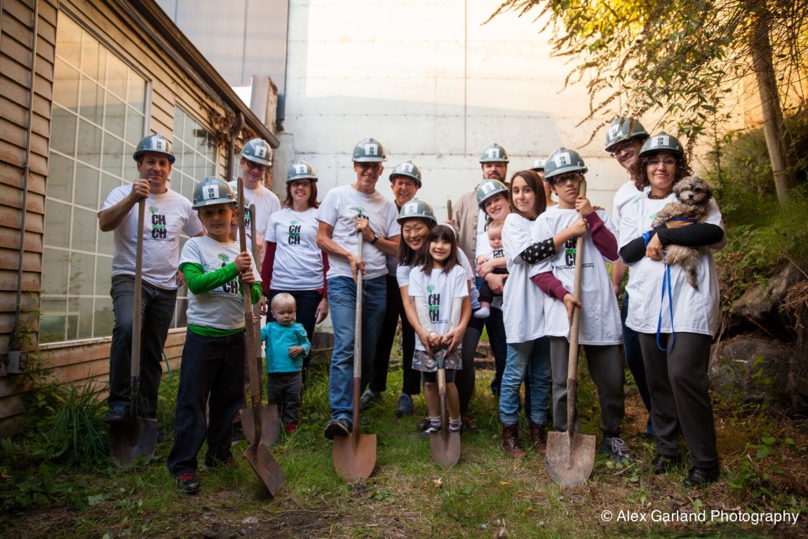 Group of volunteers planting trees in an urban community garden.
