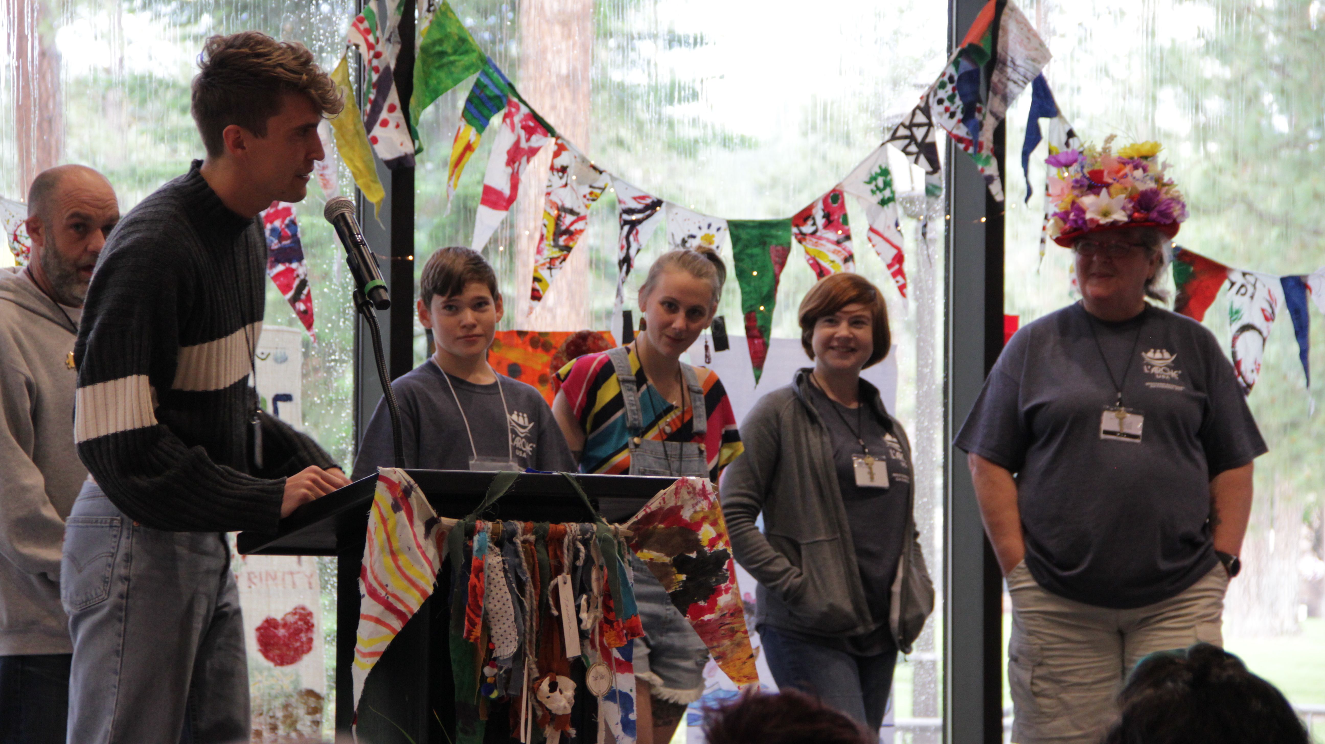 Group of diverse people at community event with colorful decorations.