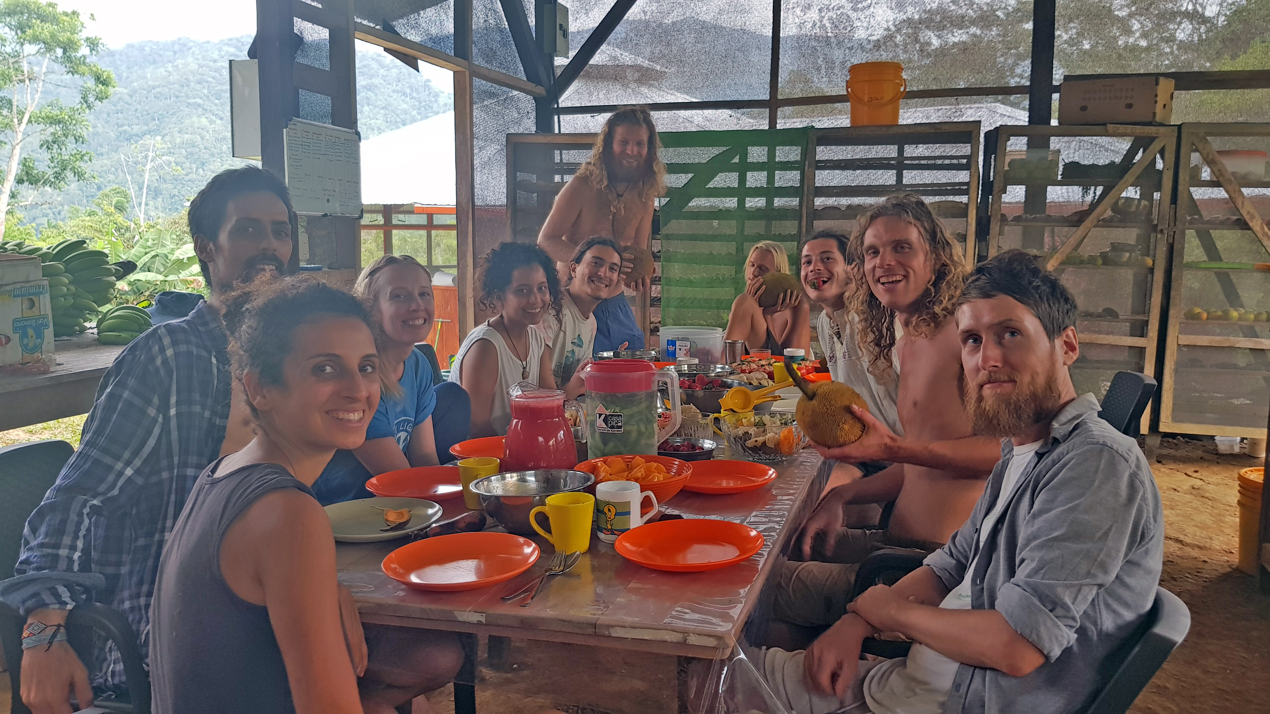 Group of people enjoying a meal together at Terra Frutis community event.