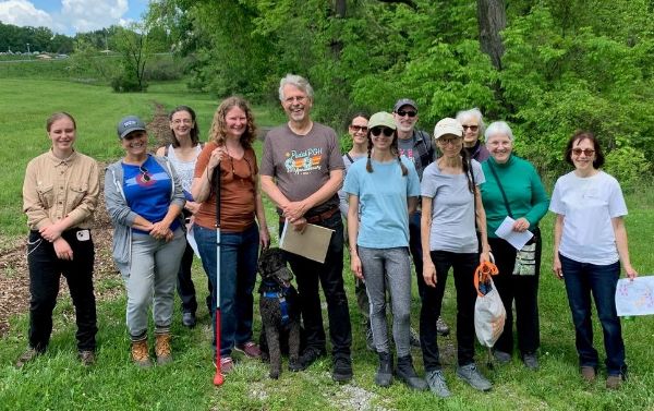 Group of diverse people outdoors at Rachel Carson EcoVillage.