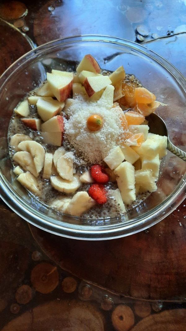 Mixed fruit and nuts in a glass bowl for dessert.