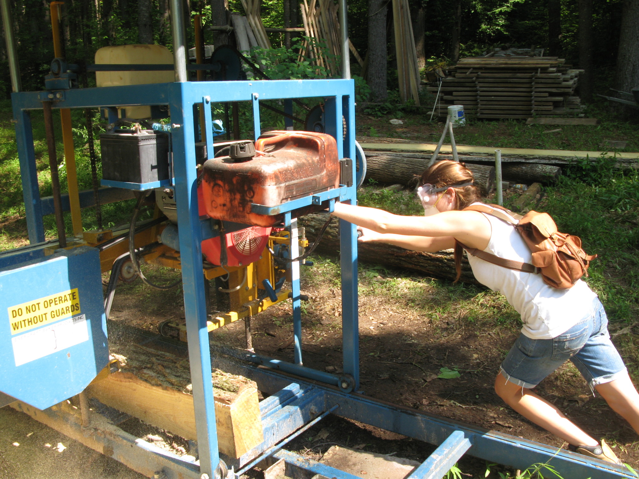 Young woman operating hydroelectric generator outdoors at Coweeta Heritage Center.