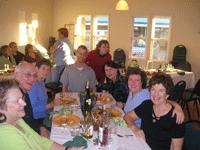 Group of people enjoying a meal together at Pleasant Hill Cohousing event.