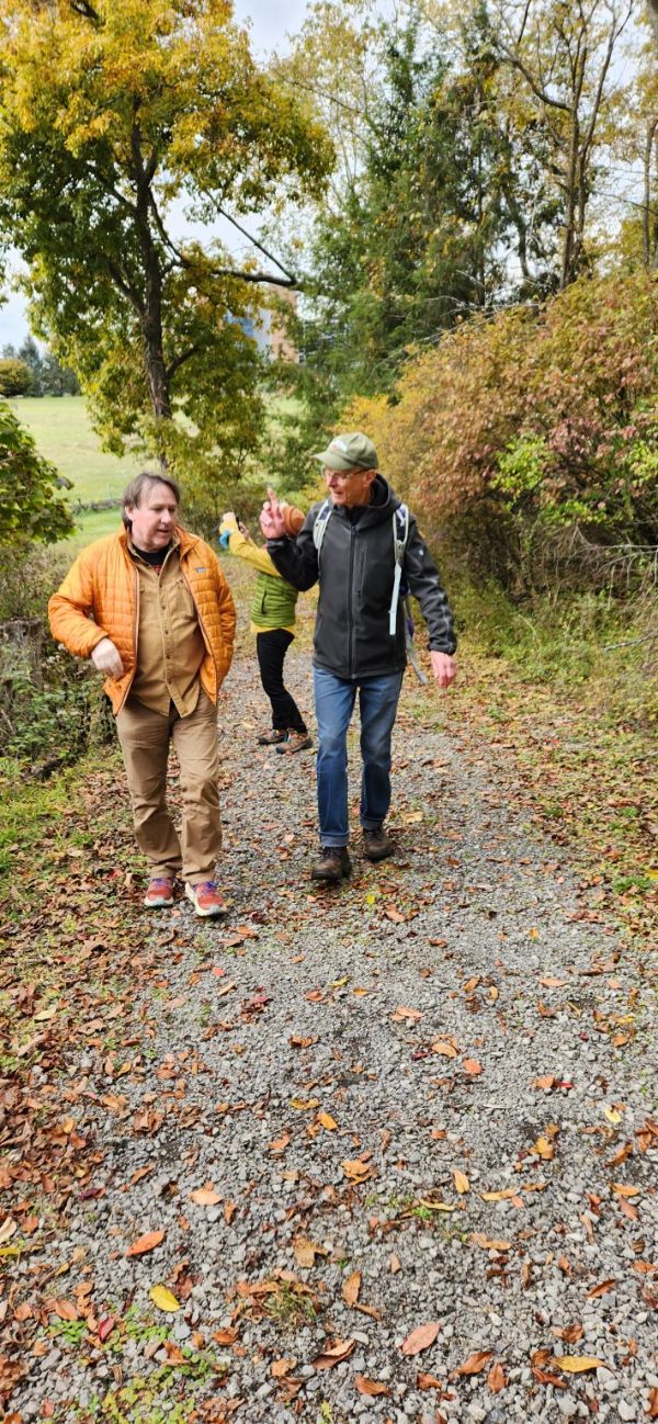 People walking and talking on a nature trail in a community setting.
