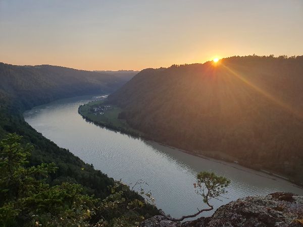 Beautiful river landscape at sunset in GrafenAuenland with hills and trees.