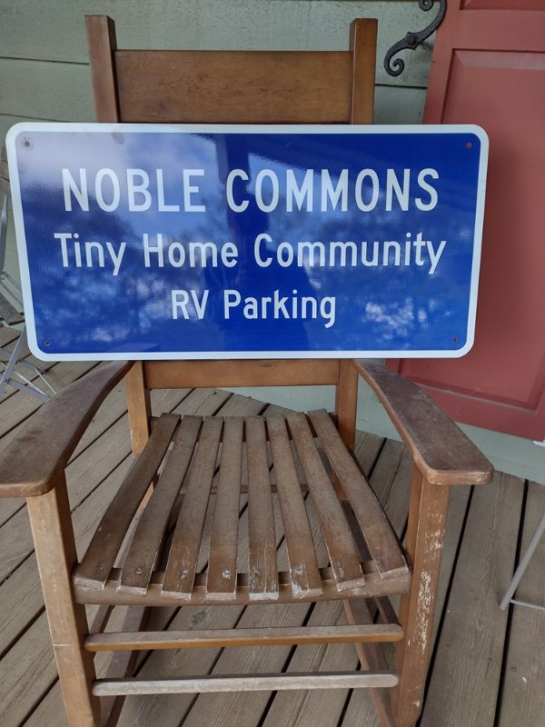 Sign for Noble Commons Tiny Home Community and RV Parking.