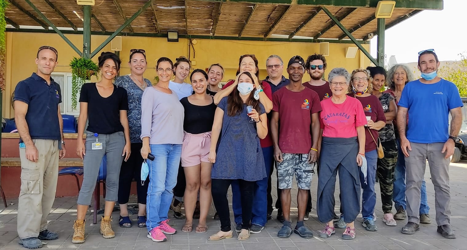 Group of diverse people at Kibbutz Ketura community event.