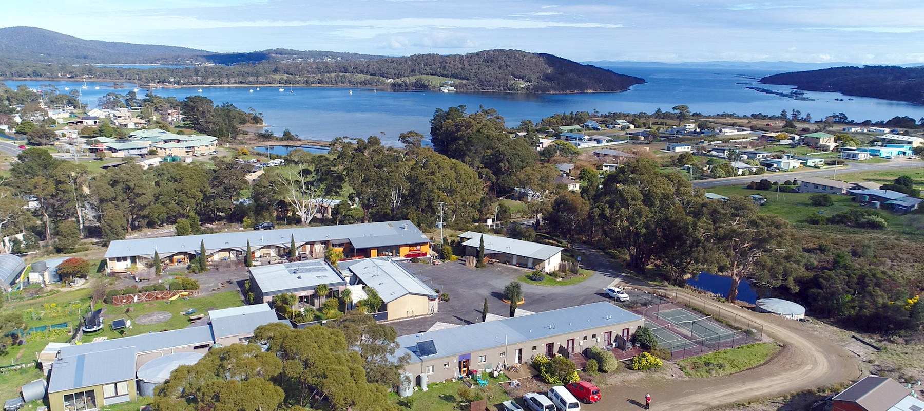 Aerial view of Tasman Ecovillage with sustainable homes and natural surroundings.
