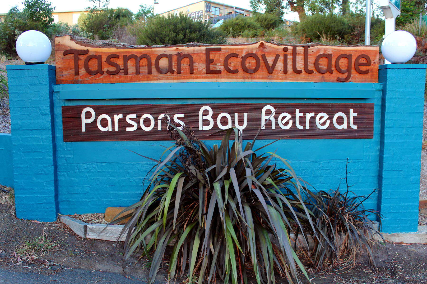 Entrance sign for Tasman Ecovillage at Parsons Bay Retreat in New Zealand.