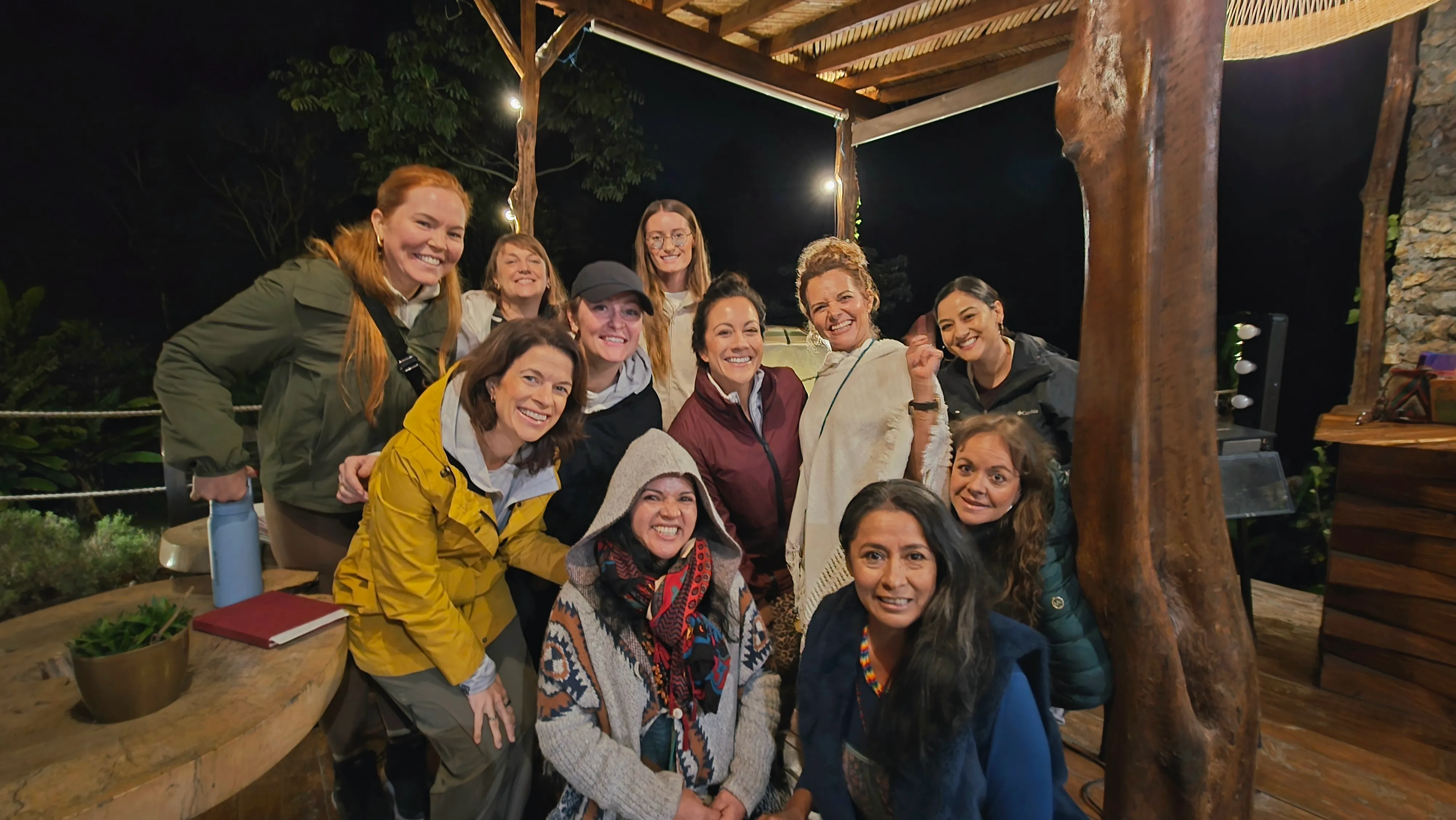 Group of people smiling at night during community event at Camino al Sol.