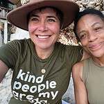 Two women smiling outdoors at Foundation for Intentional Community event.