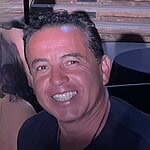 Smiling man at Foundation for Intentional Community event.