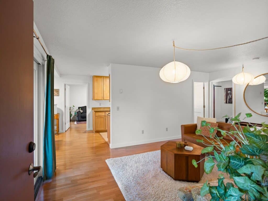 Bright living room with modern decor and natural light in Portland co-housing unit.