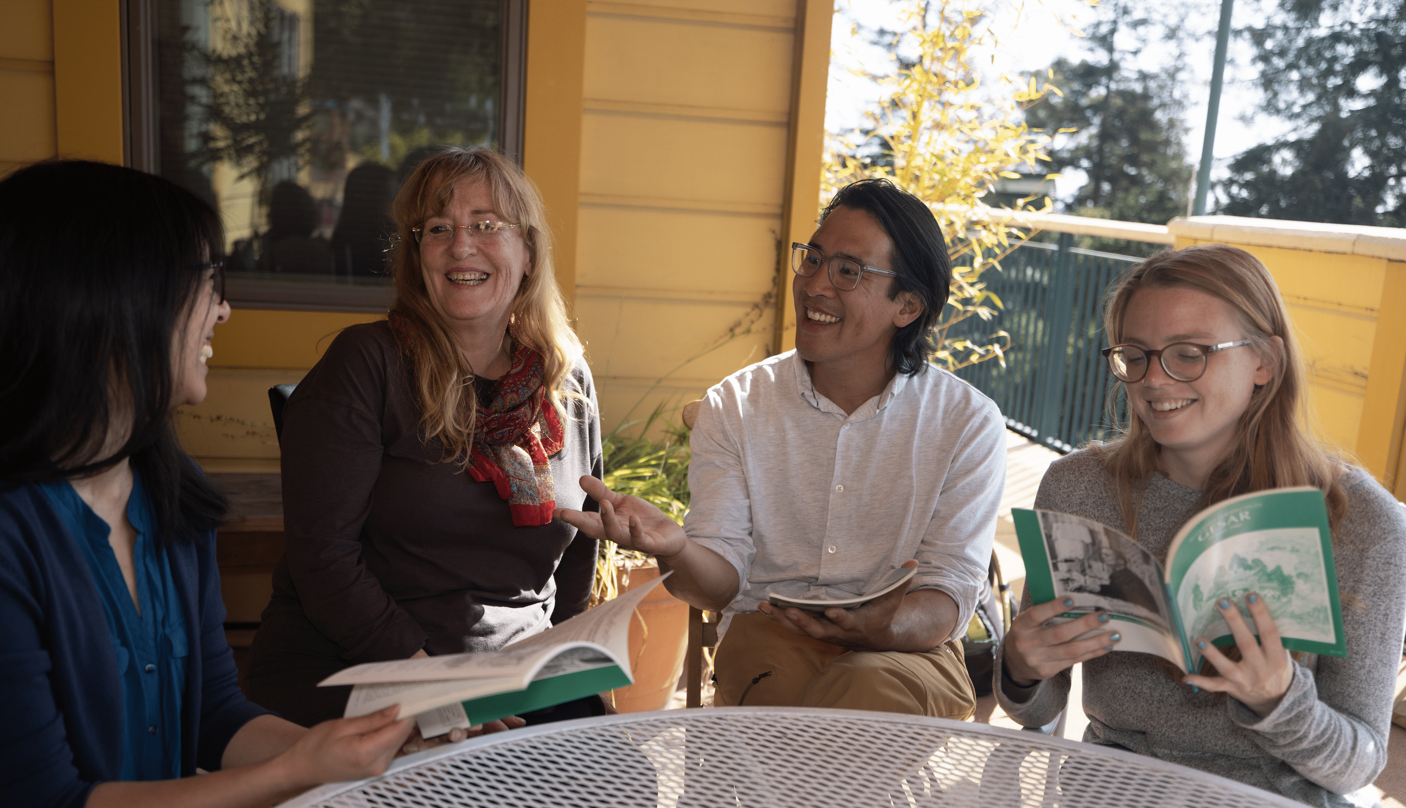 Group of diverse people engaging in a lively discussion outdoors.