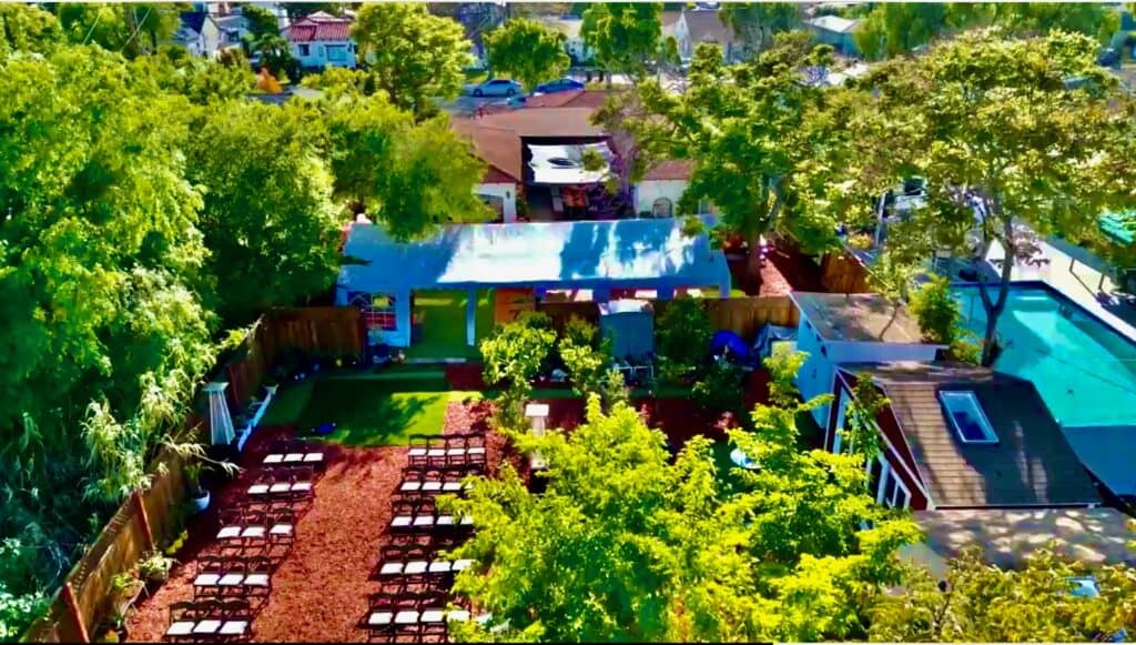 Aerial view of a community garden with seating, trees, and shared spaces.