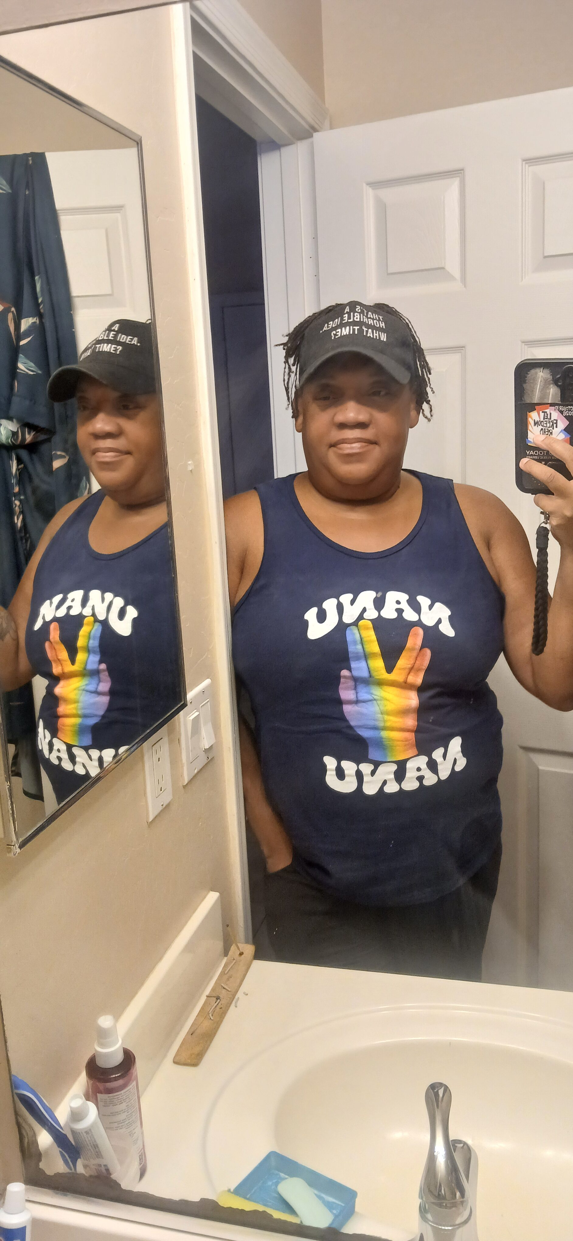 Woman taking mirror selfie at Foundation for Intentional Community event.