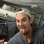Person sticking tongue out in a casual indoor setting at Foundation for Intentional Community.