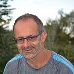 Portrait of a smiling man outdoors, representing community and connection.
