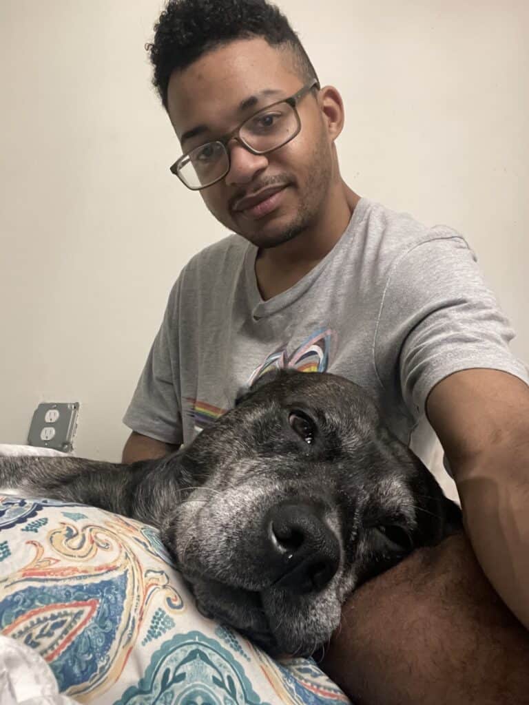 Person with dog in a cozy indoor setting for community and pet companionship.