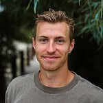 Portrait of a smiling young man outdoors for community-focused image.