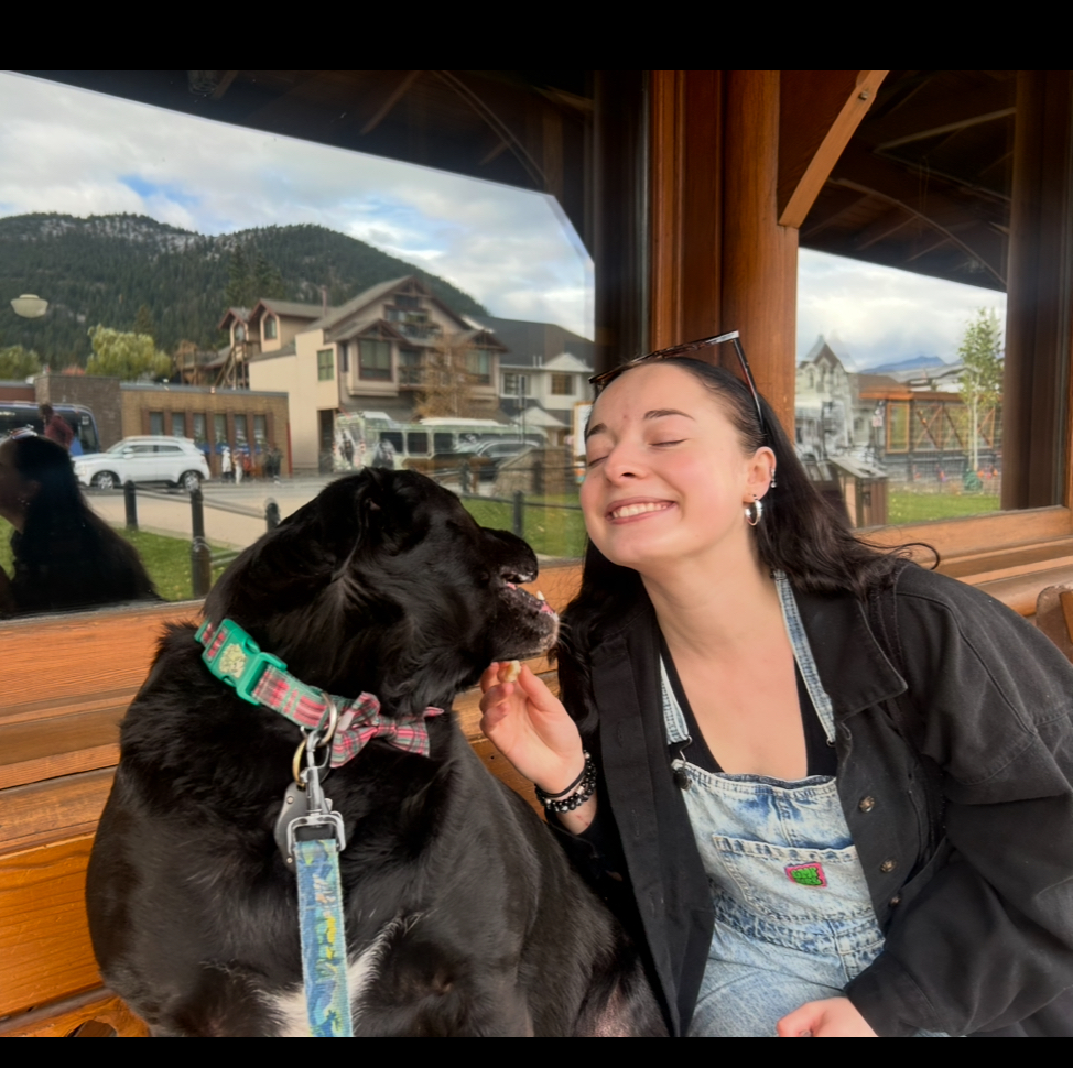 Woman smiling with dog at Foundation for Intentional Community.